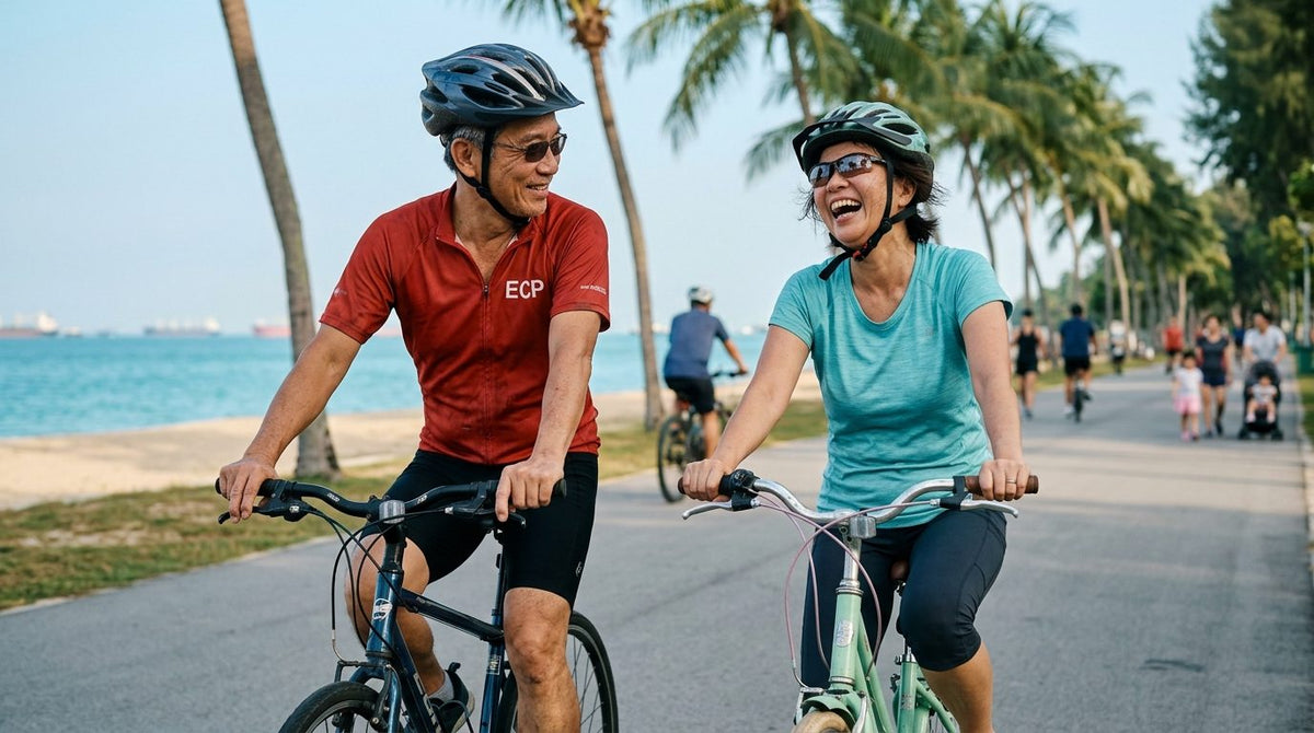 Couple laughing as they cycle together along East Coast Park